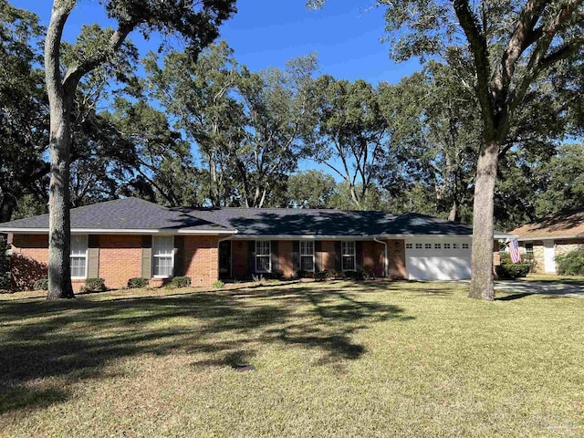 ranch-style house featuring a front lawn, an attached garage, and brick siding