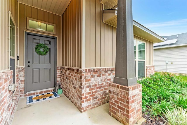 5853 Fairlands Rd, Milton, FL 32583 - entrance to property with brick siding, covered porch, and board and batten siding