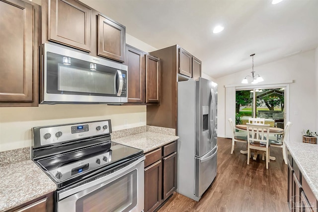 5853 Fairlands Rd, Milton, FL 32583 - kitchen with appliances with stainless steel finishes, dark wood-style flooring, a chandelier, vaulted ceiling, and hanging light fixtures