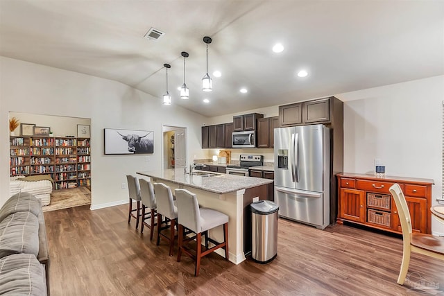 5853 Fairlands Rd, Milton, FL 32583 - kitchen with appliances with stainless steel finishes, a sink, lofted ceiling, open floor plan, and a kitchen breakfast bar