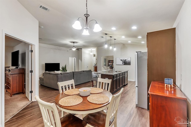 5853 Fairlands Rd, Milton, FL 32583 - dining room featuring light wood finished floors, ceiling fan, recessed lighting, and a chandelier