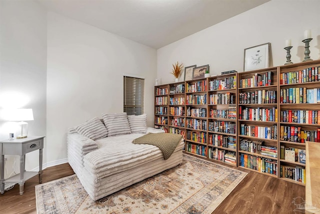 5853 Fairlands Rd, Milton, FL 32583 - living area with wood finished floors, baseboards, and wall of books