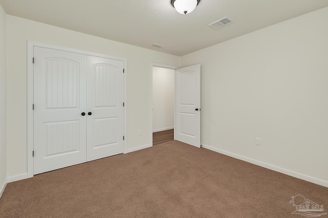 5853 Fairlands Rd, Milton, FL 32583 - unfurnished bedroom with carpet floors, baseboards, and a closet
