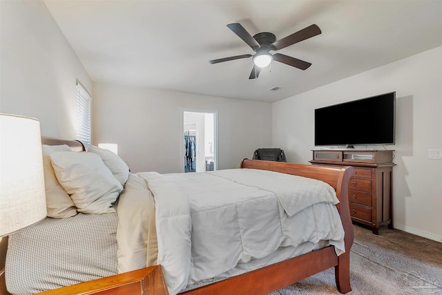5853 Fairlands Rd, Milton, FL 32583 - carpeted bedroom with ceiling fan, baseboards, and a walk in closet