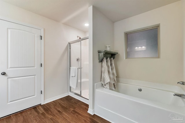 5853 Fairlands Rd, Milton, FL 32583 - bathroom with a stall shower, a garden tub, wood finished floors, and baseboards