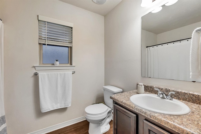 5853 Fairlands Rd, Milton, FL 32583 - bathroom featuring vanity, wood finished floors, toilet, baseboards, and a shower with curtain