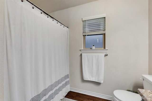 5853 Fairlands Rd, Milton, FL 32583 - bathroom featuring baseboards, toilet, wood finished floors, and a shower with shower curtain