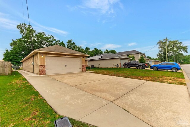 5853 Fairlands Rd, Milton, FL 32583 - view of side of home featuring brick siding, a garage, and a yard