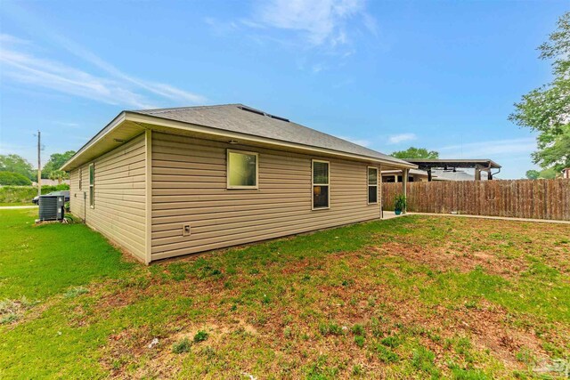 5853 Fairlands Rd, Milton, FL 32583 - back of property with central AC unit