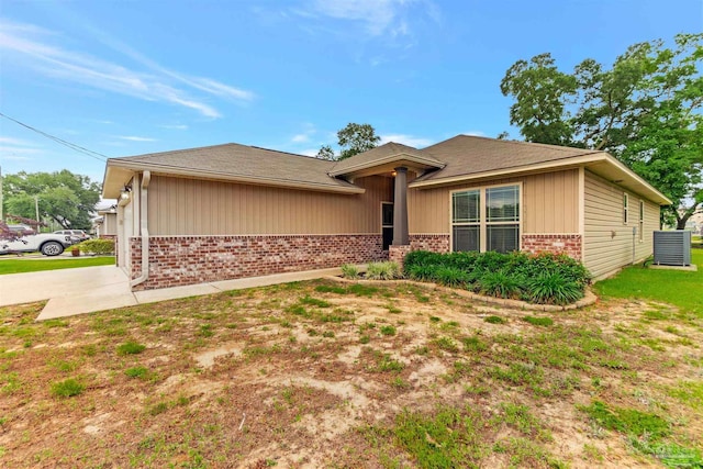 5853 Fairlands Rd, Milton, FL 32583 - view of front of property with brick siding, roof with shingles, board and batten siding, and concrete driveway