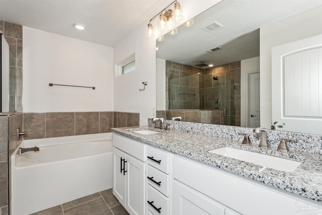 bathroom featuring tile patterned floors, separate shower and tub, and vanity