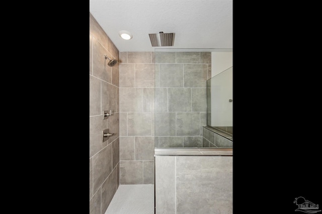 bathroom with tiled shower