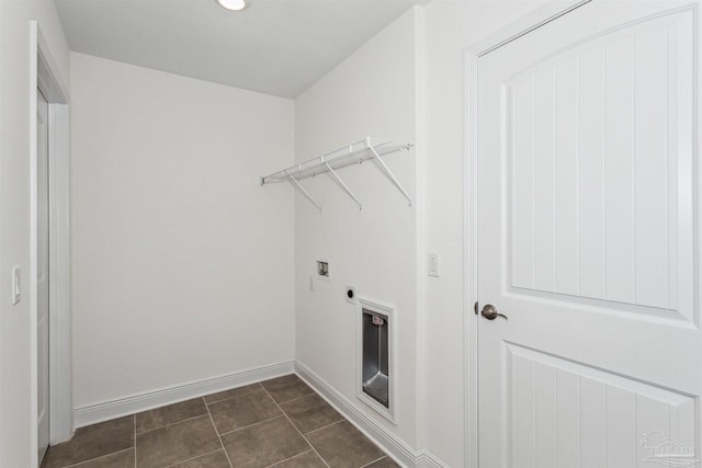 washroom featuring dark tile patterned floors, washer hookup, and electric dryer hookup