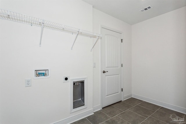 laundry room with washer hookup, dark tile patterned flooring, and electric dryer hookup