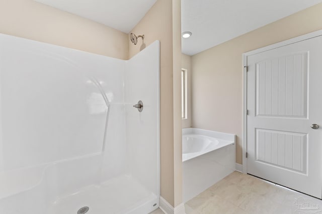 bathroom featuring separate shower and tub