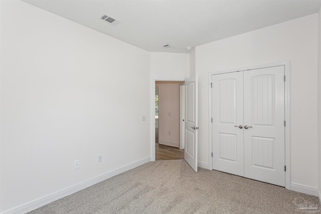 unfurnished bedroom featuring a closet and carpet floors