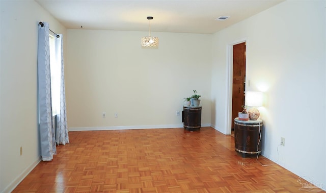 empty room with visible vents and baseboards