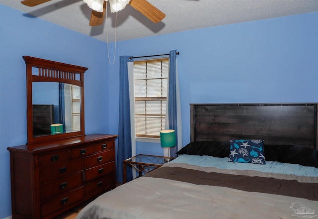 bedroom featuring a textured ceiling and a ceiling fan