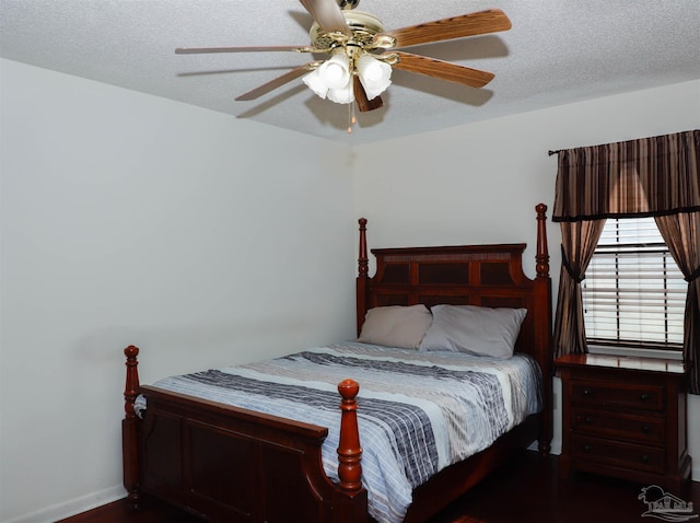 bedroom with ceiling fan and a textured ceiling