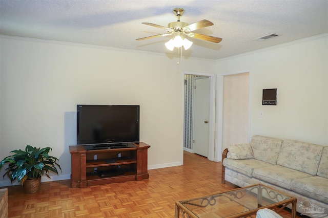 living room featuring crown molding, visible vents, and a textured ceiling