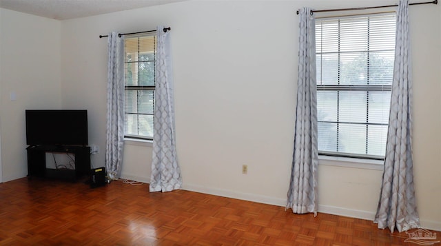 unfurnished living room with baseboards