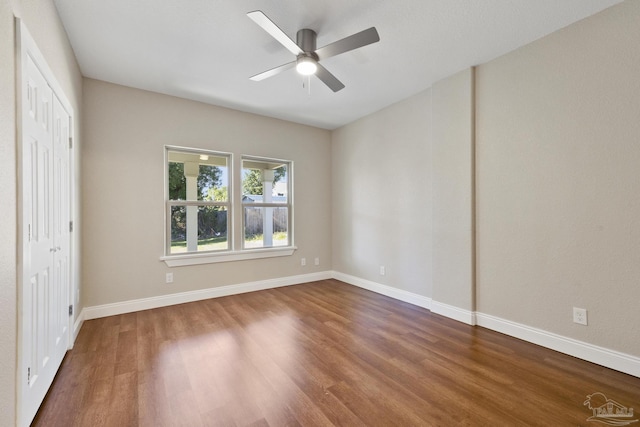 unfurnished bedroom featuring ceiling fan, wood-type flooring, and a closet