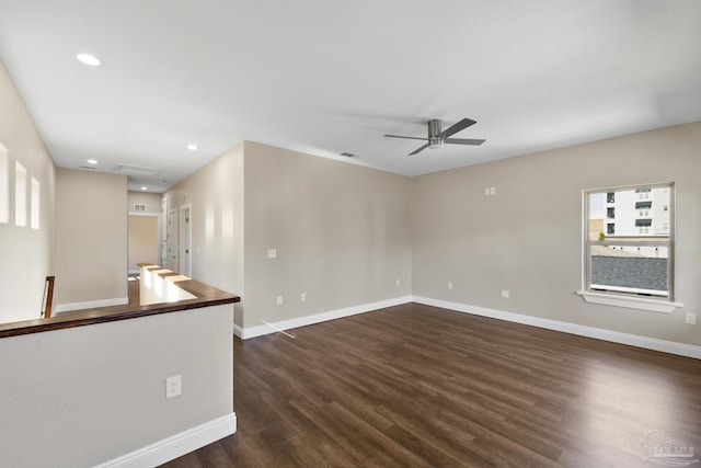 empty room with dark wood-type flooring and ceiling fan