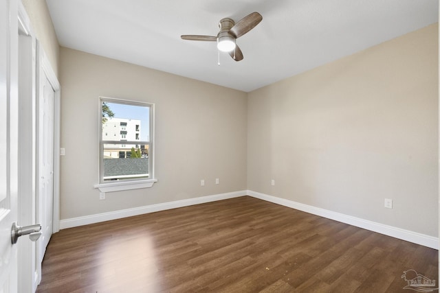 spare room with ceiling fan and dark hardwood / wood-style flooring