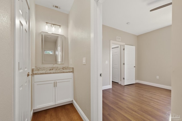 bathroom featuring ceiling fan, vanity, and hardwood / wood-style floors