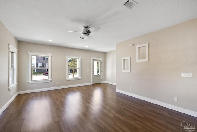 spare room featuring ceiling fan and dark hardwood / wood-style flooring