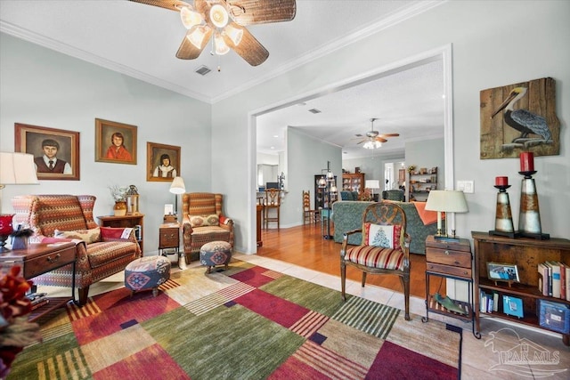 living room with ornamental molding, light wood-type flooring, and ceiling fan