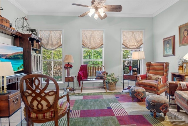 living area with ornamental molding and ceiling fan