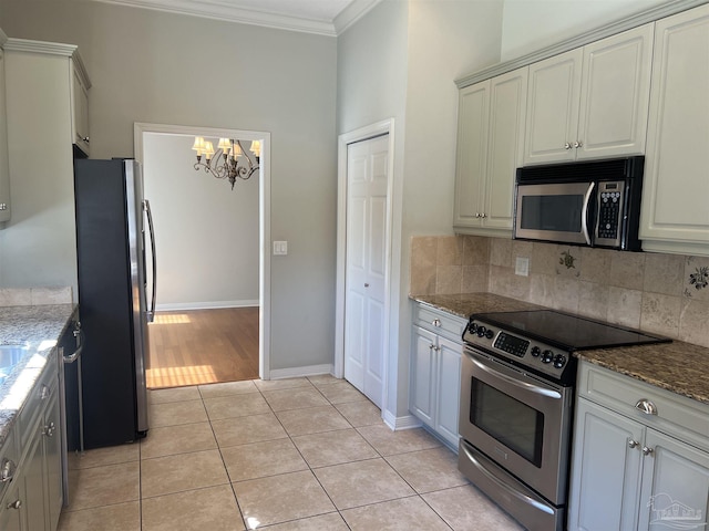 kitchen featuring ornamental molding, light tile patterned flooring, a chandelier, appliances with stainless steel finishes, and backsplash
