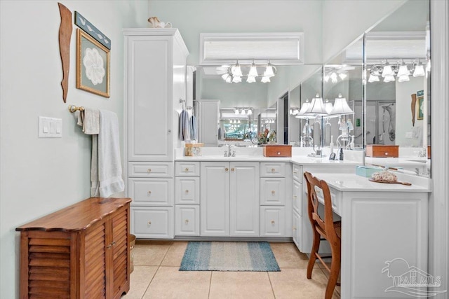 bathroom featuring tile patterned floors, a chandelier, and vanity
