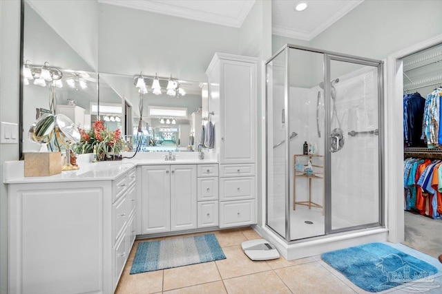 bathroom with vanity, crown molding, a shower with shower door, and tile patterned flooring