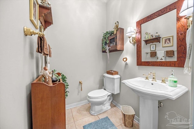 bathroom with toilet and tile patterned flooring