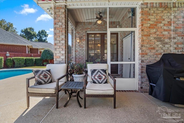 view of patio / terrace featuring grilling area, ceiling fan, fence, and a fenced in pool