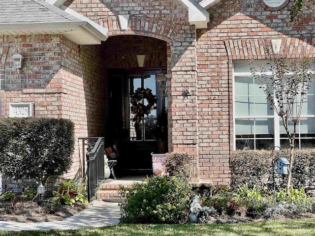 property entrance featuring brick siding