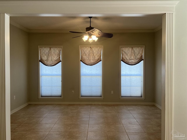 unfurnished room with baseboards, ornamental molding, a ceiling fan, and light tile patterned flooring