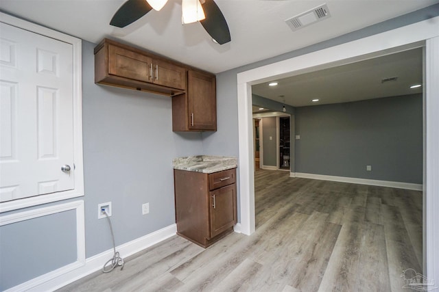 kitchen featuring ceiling fan and light wood-type flooring