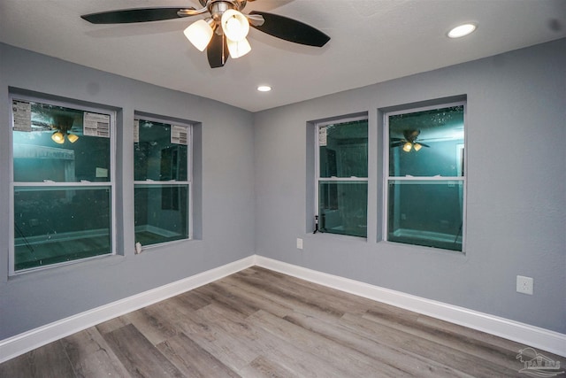 empty room featuring wood-type flooring and ceiling fan