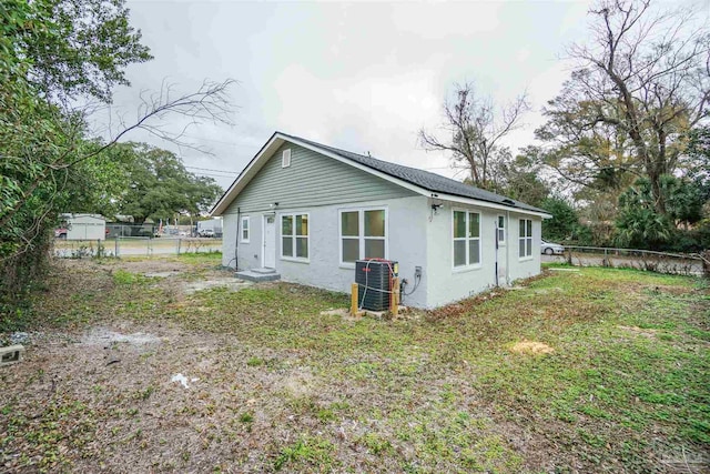 view of home's exterior with a yard and central air condition unit