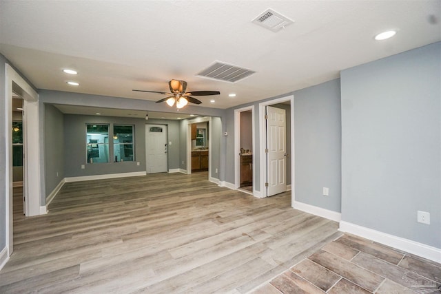 empty room featuring ceiling fan and light wood-type flooring