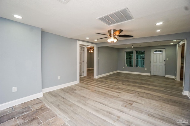 empty room featuring ceiling fan and hardwood / wood-style floors