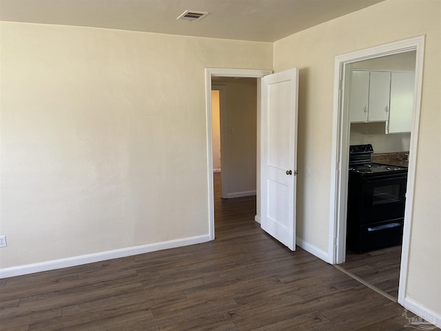 empty room featuring dark hardwood / wood-style flooring