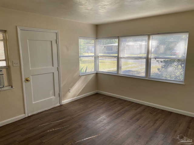 spare room with dark hardwood / wood-style floors