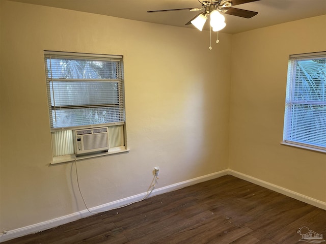 spare room with ceiling fan, cooling unit, dark wood-type flooring, and a wealth of natural light