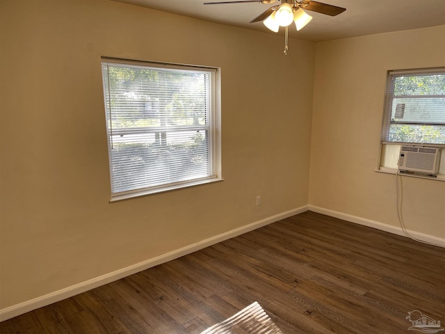 unfurnished room with ceiling fan, a wealth of natural light, cooling unit, and dark hardwood / wood-style flooring