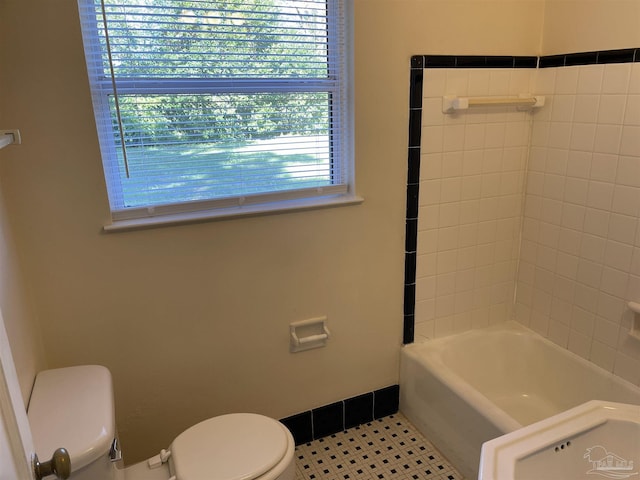 bathroom with toilet and tile patterned flooring