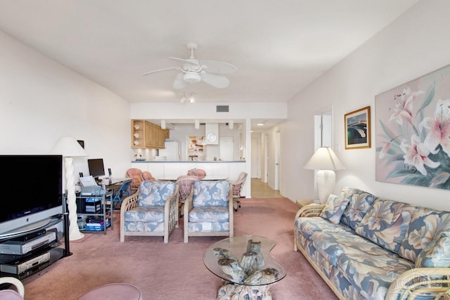 carpeted living room featuring ceiling fan